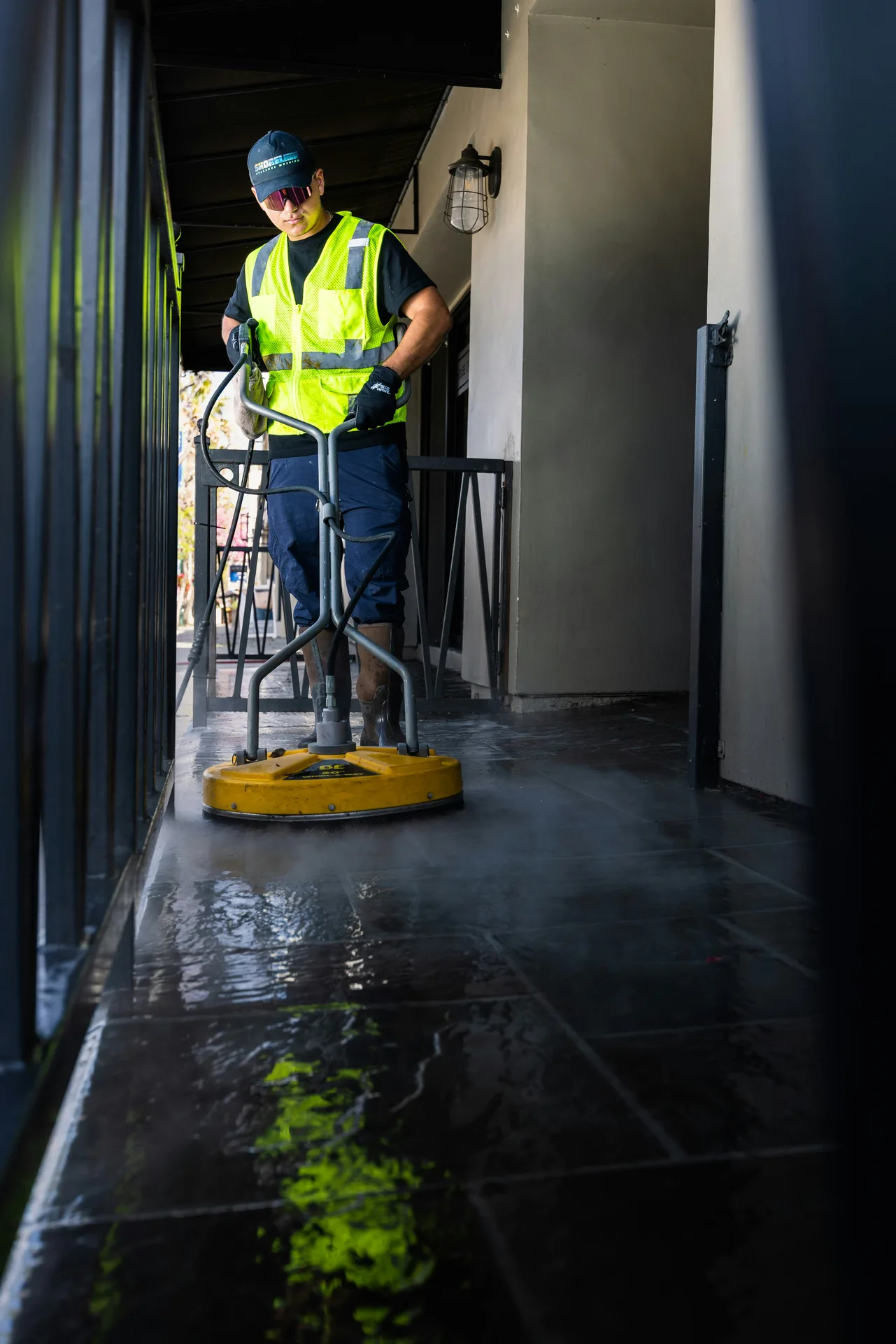 Technician Using Surface Cleaner on /oil-stain-removal/ — Minneapolis Power Washing Minneapolis